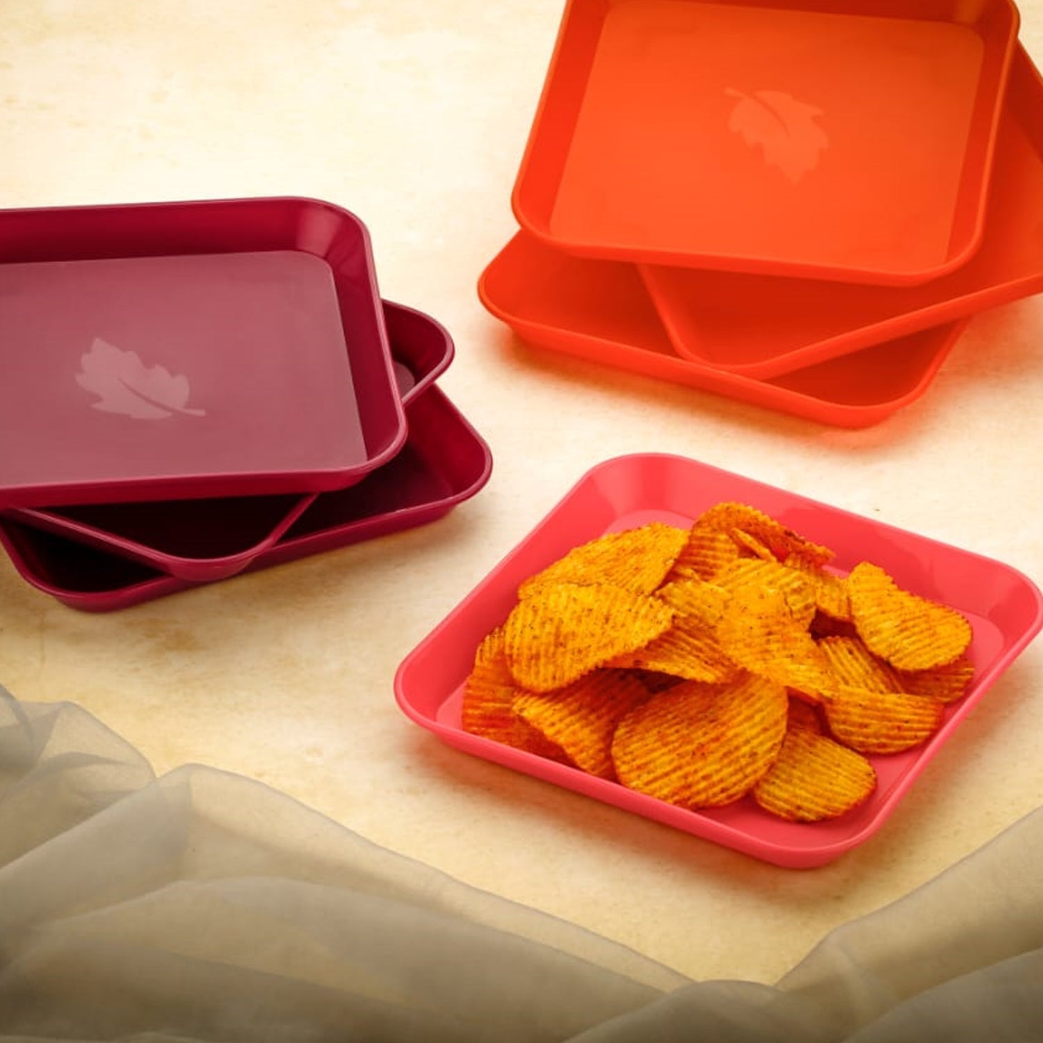 Colorful square plates on a table.