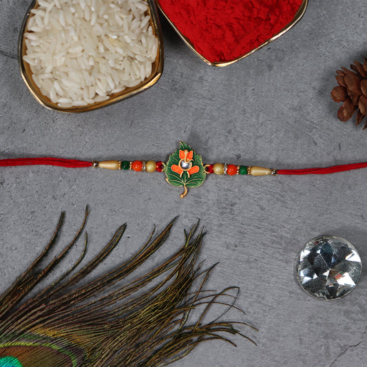 Green Tulsi Leaf Rakhi With Orange Enamel Flower And Beaded Thread