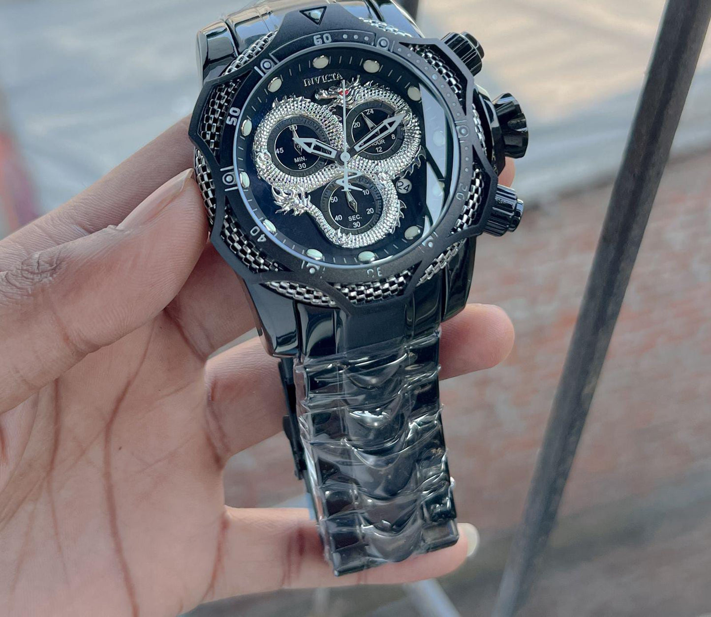 Invicta venome luxury chronograph watch, featuring a striking gold dial with a detailed snake design,