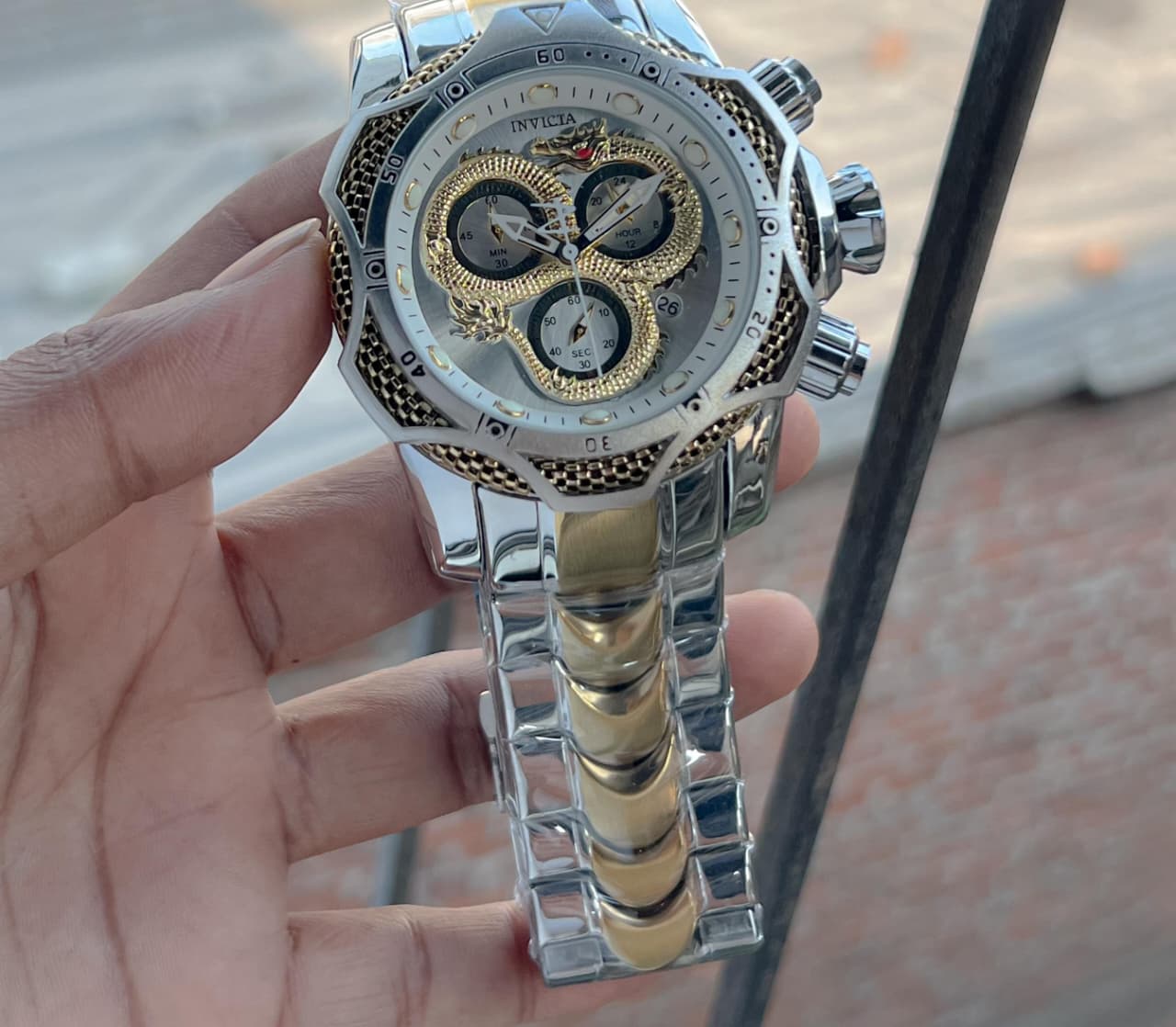 Invicta venome luxury chronograph watch, featuring a striking gold dial with a detailed snake design,